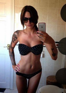Amazing handsome brunette with tattooed body in perverse lingerie on her big busty tits