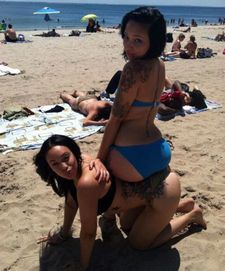 Tattooed ebony girlfriends on the beach