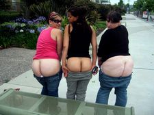 Three beautiful ladies showing off their bare bottoms.