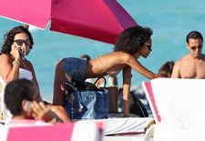 Anais Mali celebrity bikini black black hair non nude skinny beach glasses solo curly..